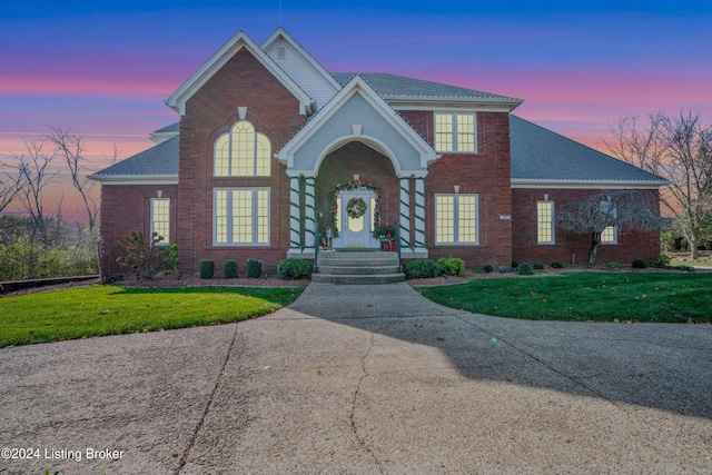 view of property featuring a lawn