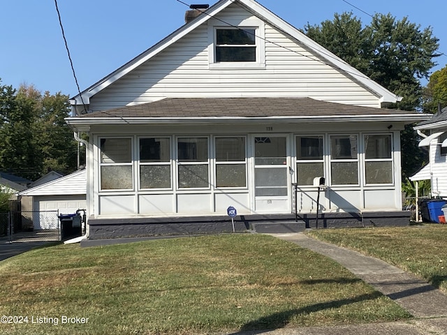 bungalow-style home with a sunroom and a front yard