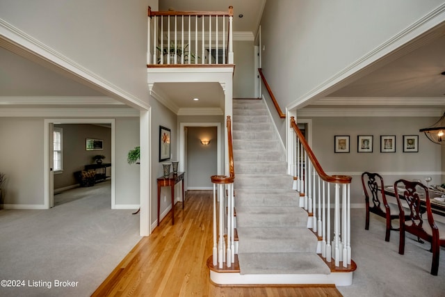 foyer with wood-type flooring and ornamental molding