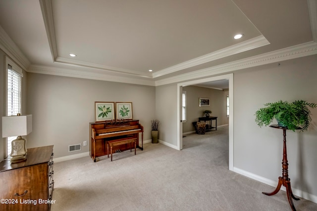 sitting room with crown molding, light carpet, and a tray ceiling