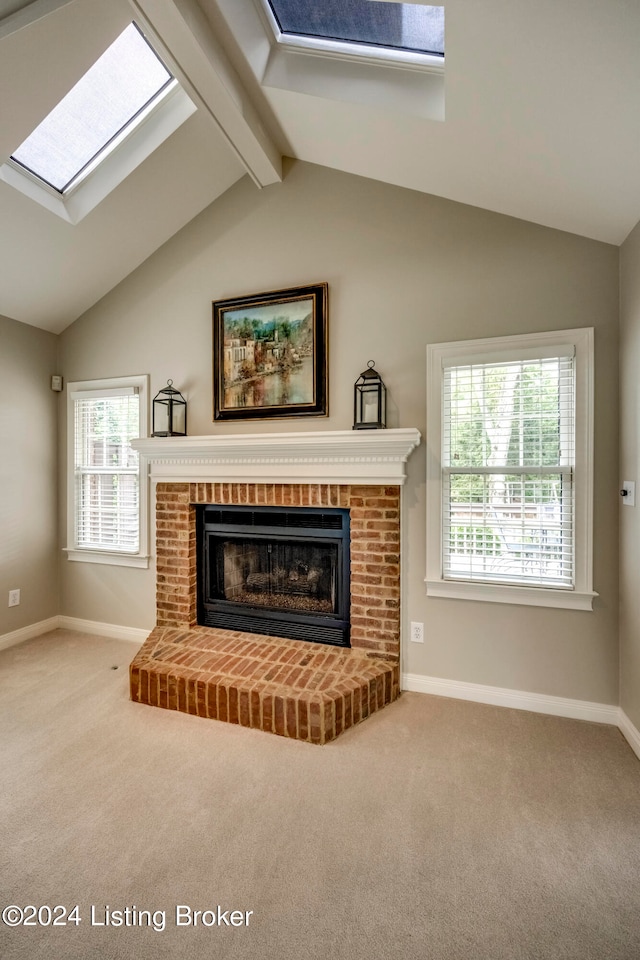 carpeted living room featuring a fireplace and lofted ceiling with skylight