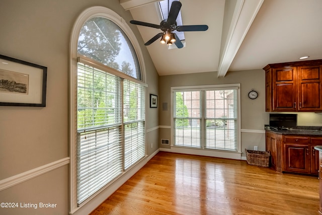 entryway featuring ceiling fan, lofted ceiling with beams, and light hardwood / wood-style flooring