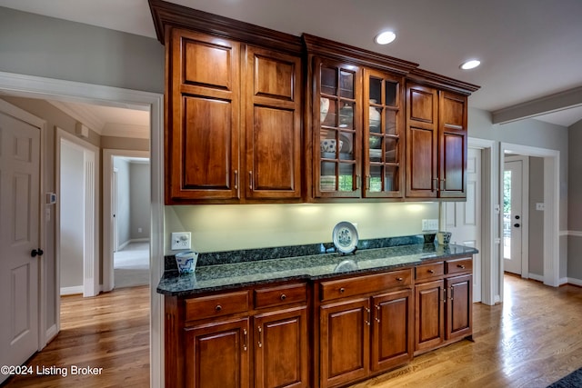 kitchen featuring dark stone counters and light hardwood / wood-style floors