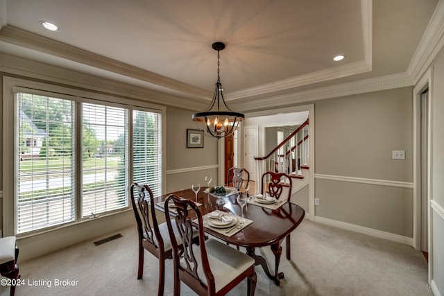 dining space with a chandelier, carpet floors, a tray ceiling, and a healthy amount of sunlight