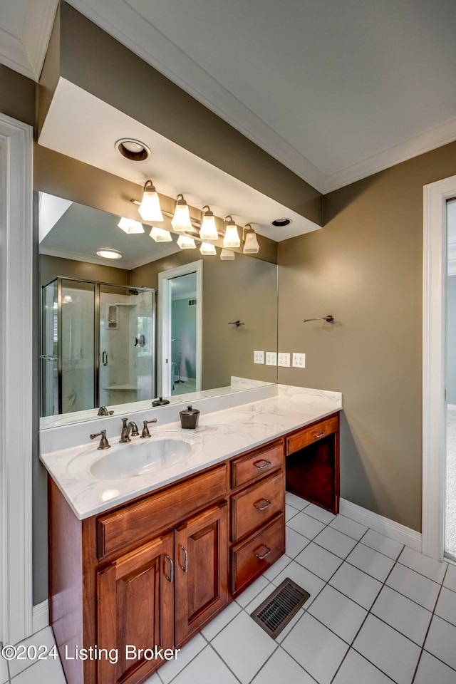 bathroom with vanity, tile patterned floors, a shower with door, and ornamental molding