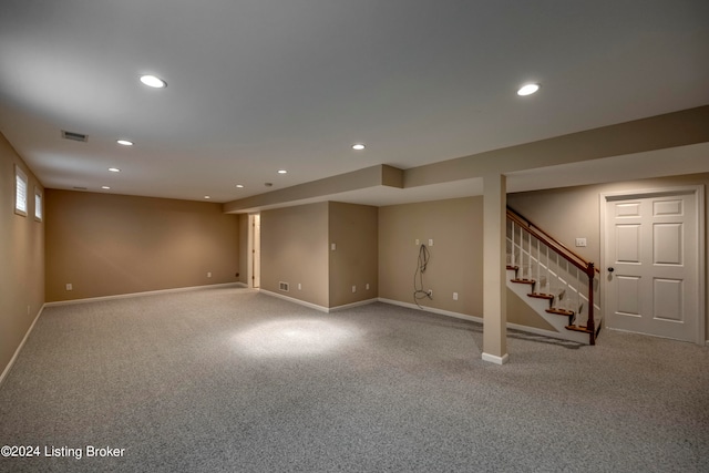 basement featuring light colored carpet