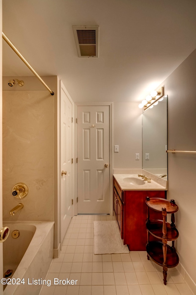 bathroom featuring vanity, tiled shower / bath combo, and tile patterned floors