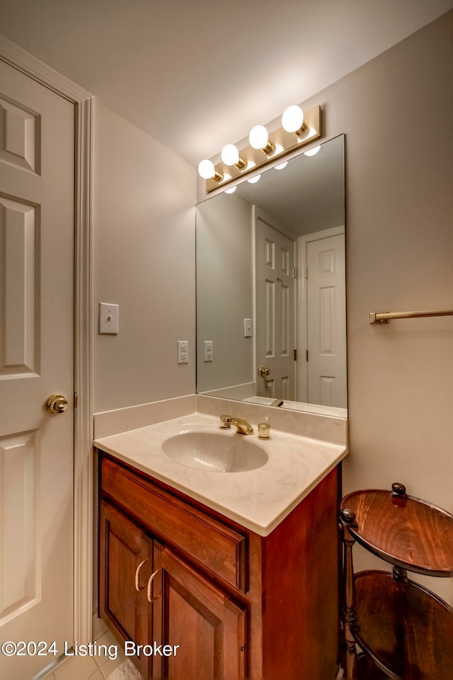 bathroom with tile patterned flooring and vanity