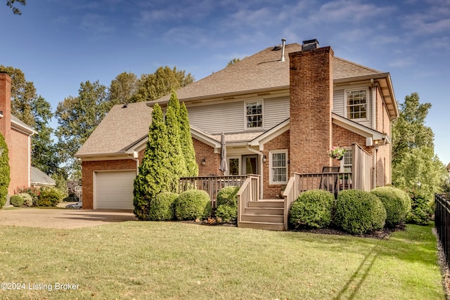 view of front of property with a garage, a front yard, and a deck