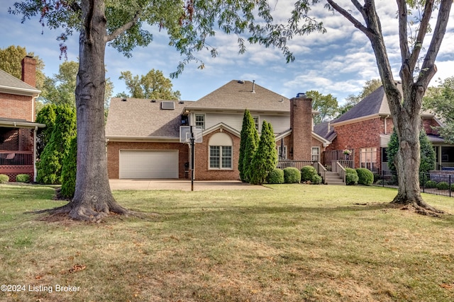 view of front facade featuring a wooden deck, a front lawn, and a garage