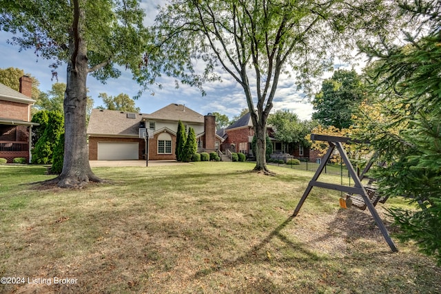 view of yard with a garage and a playground