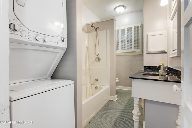 bathroom with vanity, shower / bath combination, stacked washing maching and dryer, and tile patterned floors