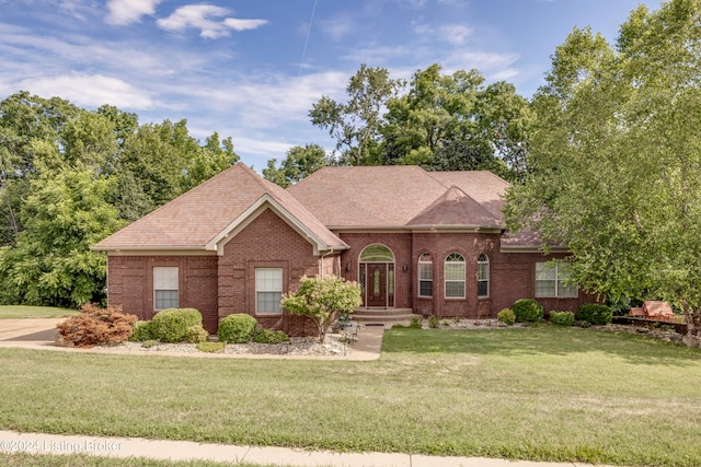 ranch-style home with a front lawn