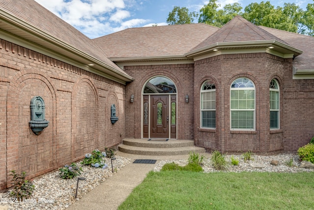 entrance to property with a lawn