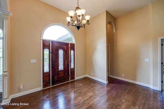 entryway featuring dark wood-type flooring and a notable chandelier