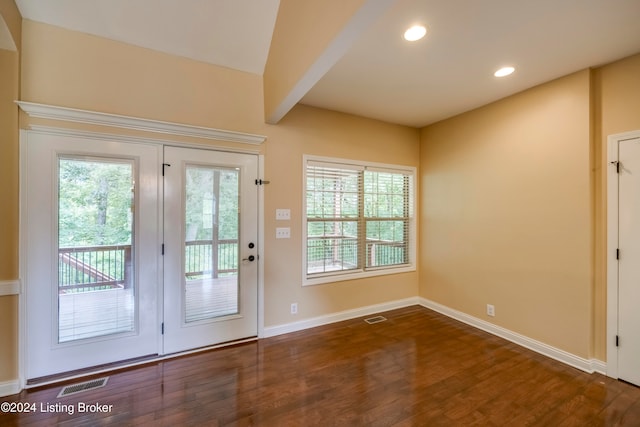 doorway featuring plenty of natural light, dark hardwood / wood-style floors, and beam ceiling