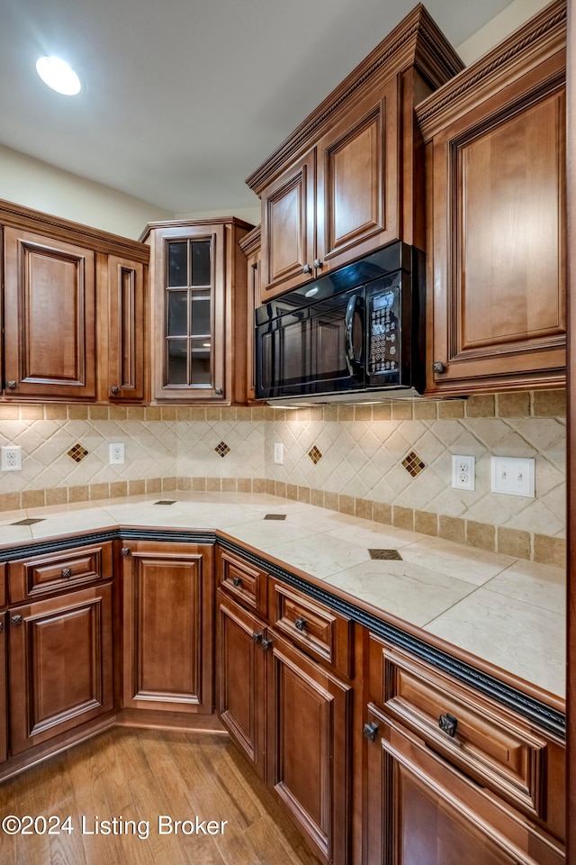 kitchen featuring backsplash and light hardwood / wood-style floors