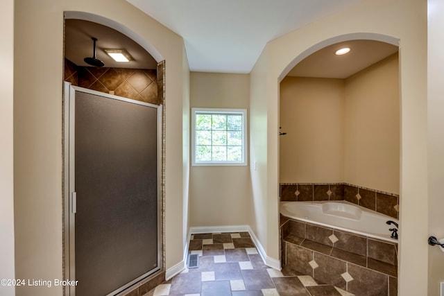 bathroom featuring independent shower and bath