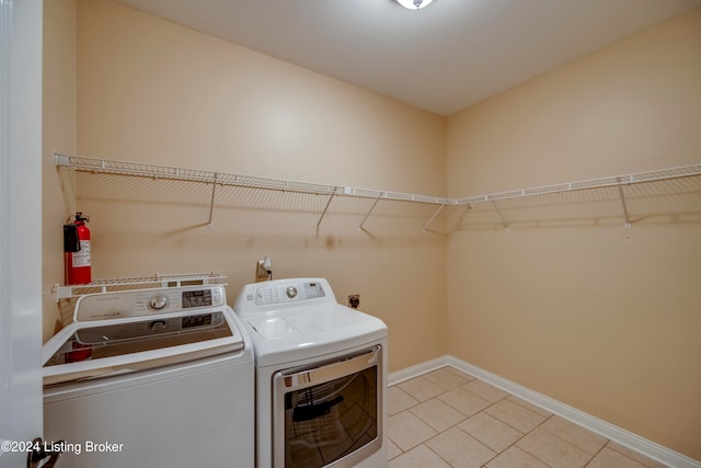 clothes washing area with separate washer and dryer