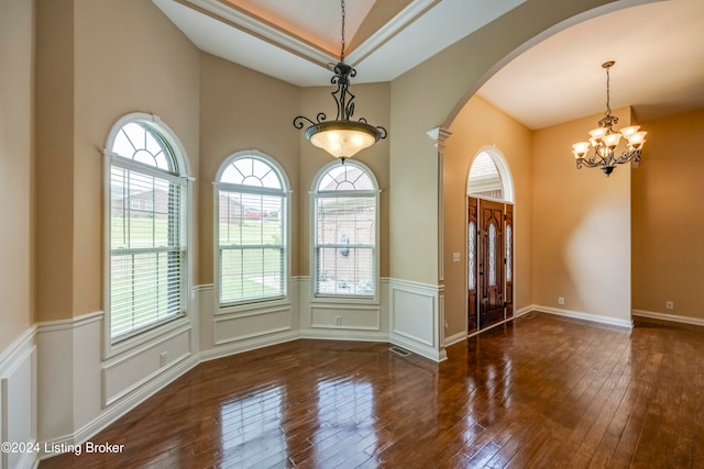 entryway featuring a healthy amount of sunlight, dark hardwood / wood-style flooring, and a chandelier