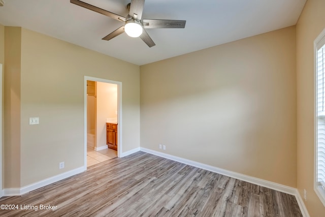 spare room featuring ceiling fan and light hardwood / wood-style floors