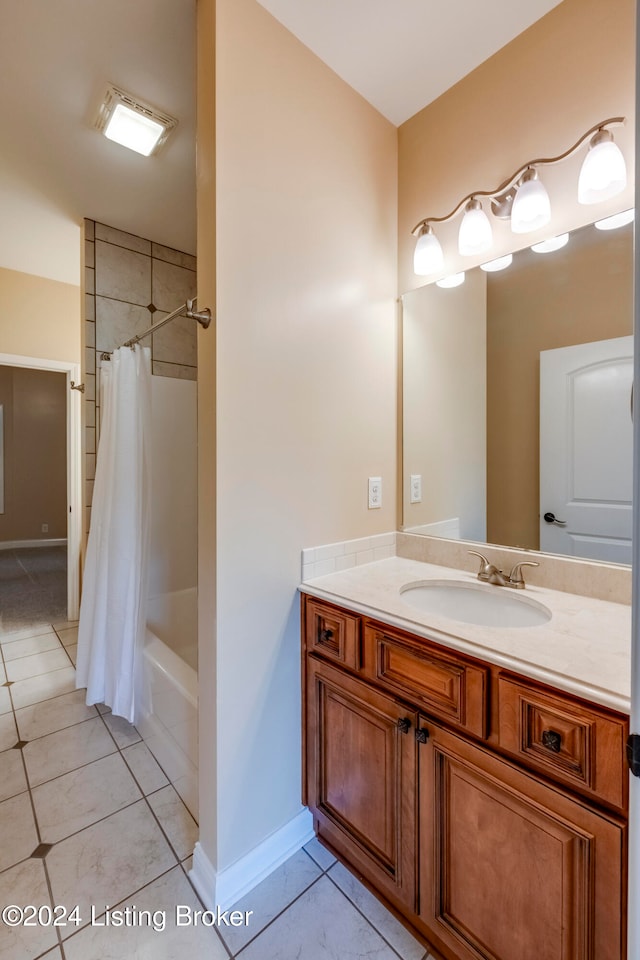 bathroom with tile patterned floors, vanity, and shower / tub combo with curtain