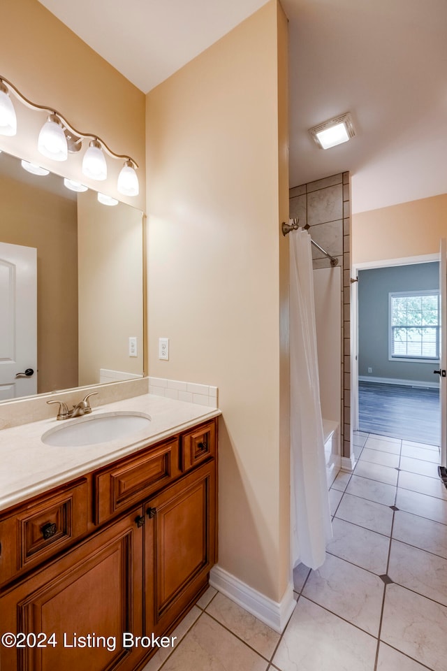 bathroom with tile patterned flooring, vanity, and shower / tub combo