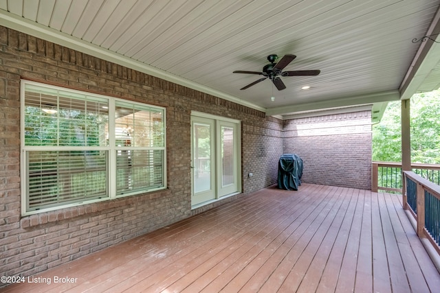 deck featuring area for grilling and ceiling fan