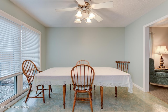 dining area featuring a textured ceiling and ceiling fan