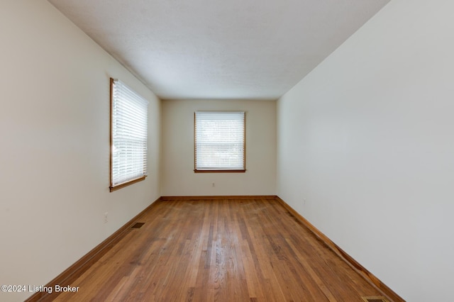 spare room featuring hardwood / wood-style floors