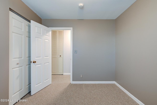 unfurnished bedroom with light colored carpet