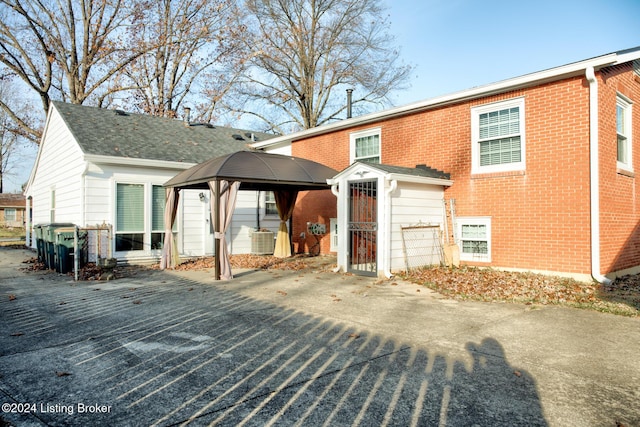 view of front of property featuring a gazebo and central air condition unit