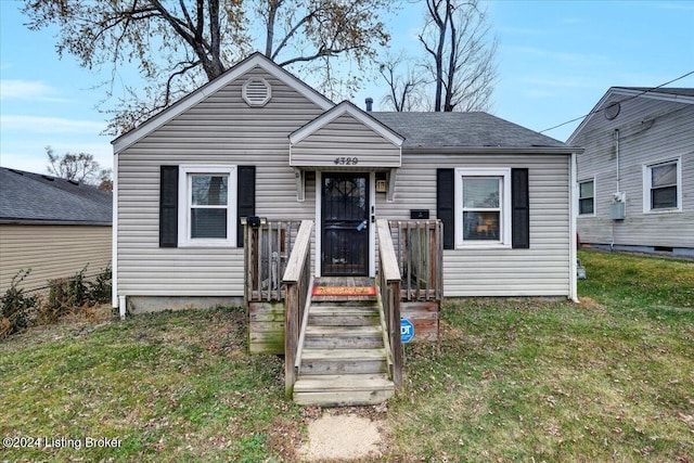 bungalow-style house featuring a front yard