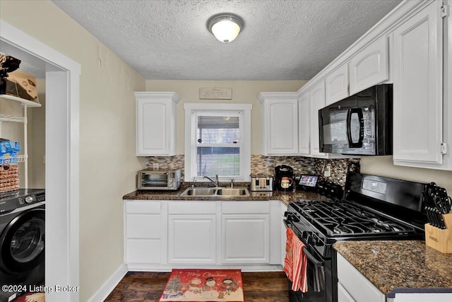 kitchen with black appliances, sink, washer / dryer, and white cabinets