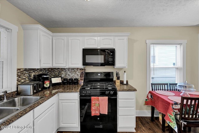 kitchen with tasteful backsplash, sink, white cabinets, and black appliances