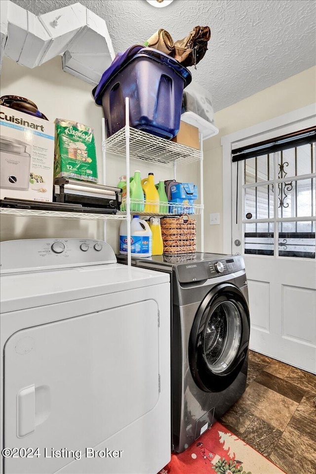 laundry room with separate washer and dryer and a textured ceiling