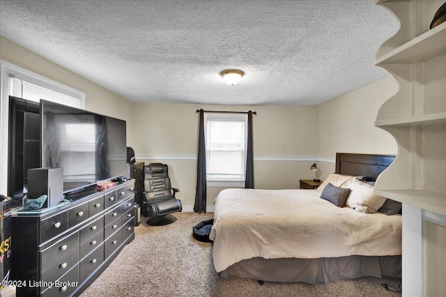 bedroom with a textured ceiling and carpet floors