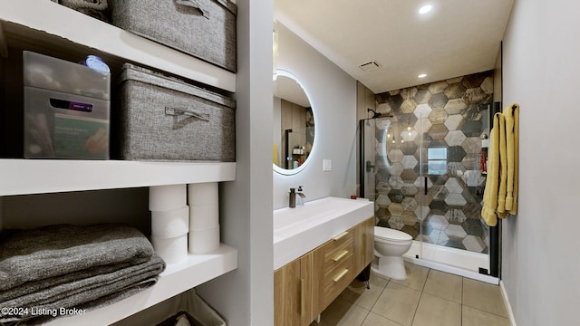 bathroom with toilet, vanity, tile patterned floors, and an enclosed shower