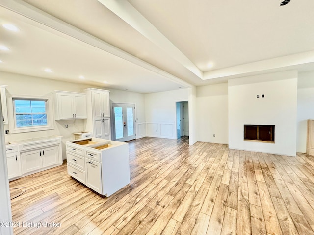 kitchen featuring white cabinets, a healthy amount of sunlight, and light hardwood / wood-style floors