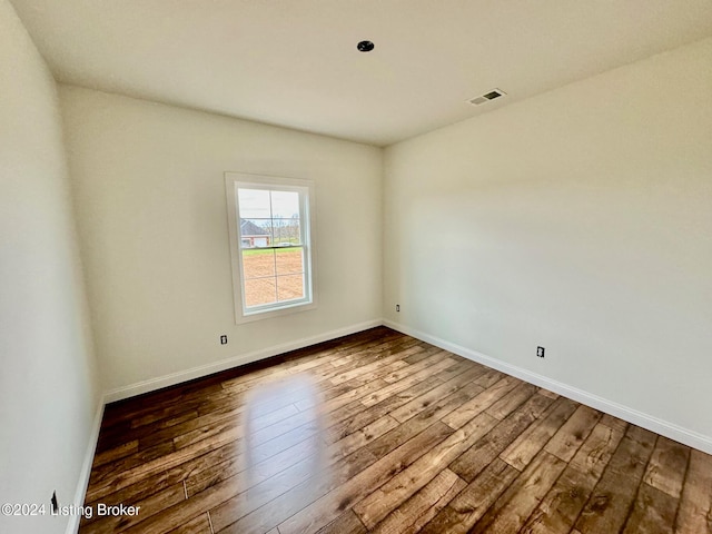 empty room with dark wood-type flooring