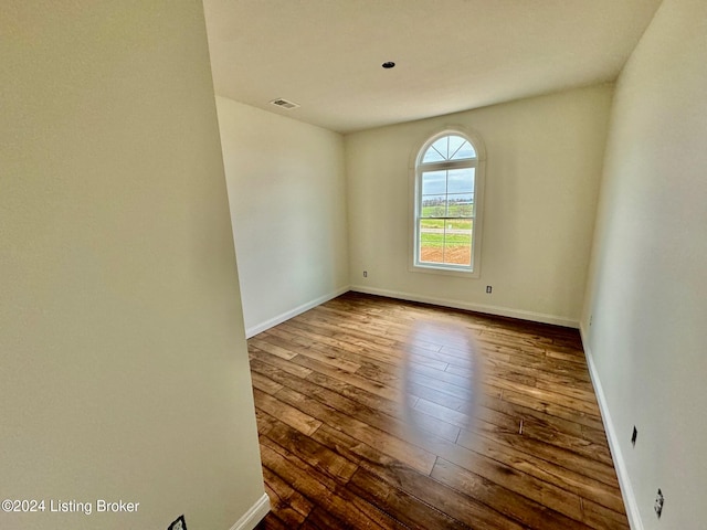 unfurnished room featuring dark hardwood / wood-style floors