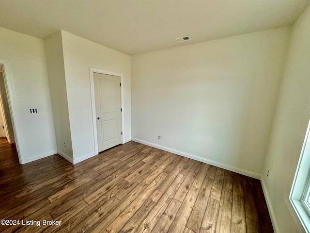 empty room with hardwood / wood-style floors