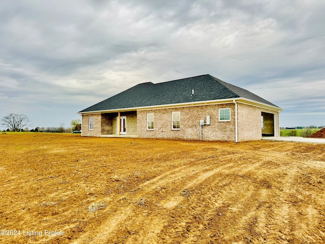 back of property with a garage