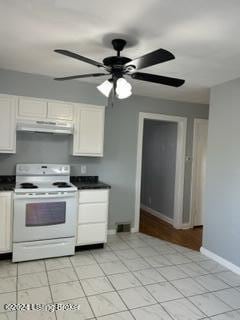 kitchen with ceiling fan, white cabinets, light tile patterned floors, and white electric range