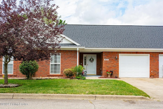 view of front facade with a front yard and a garage