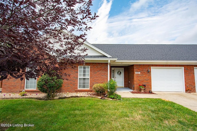 single story home featuring a front lawn and a garage