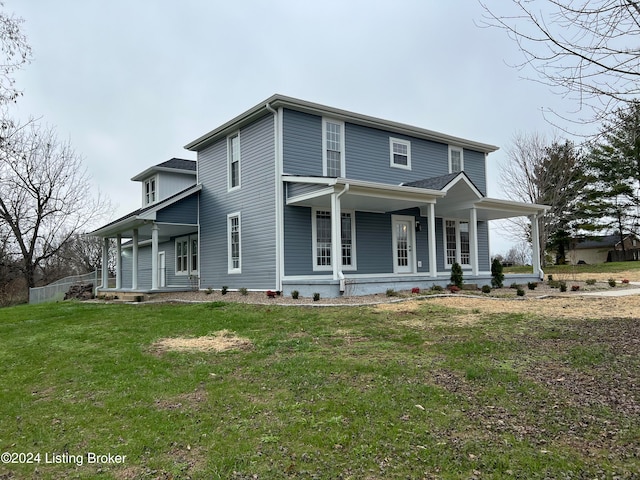 view of front of property featuring a front lawn and covered porch