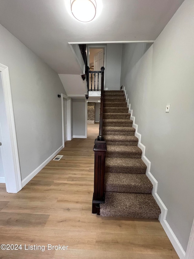 stairs with wood-type flooring