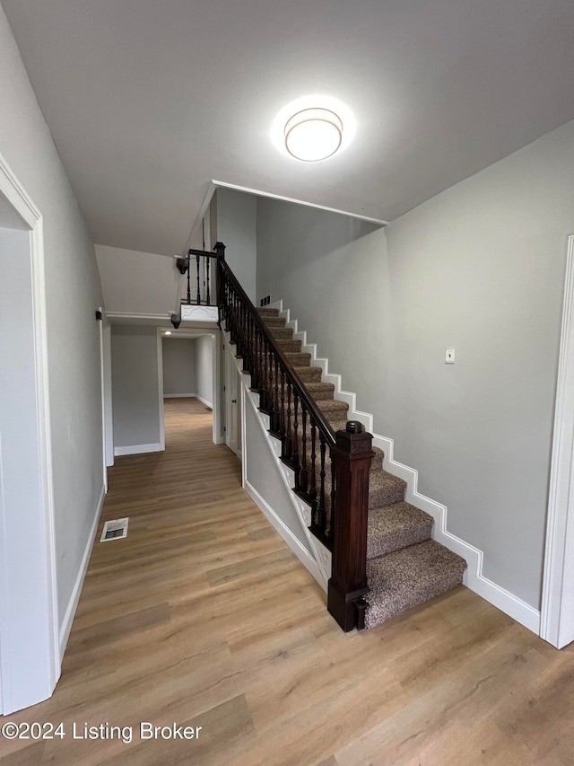 staircase featuring hardwood / wood-style floors