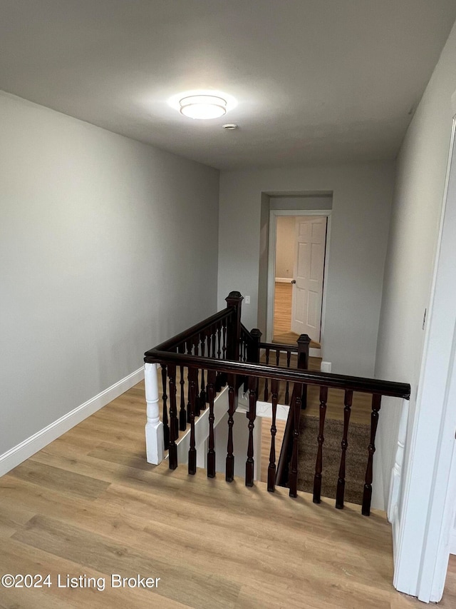 stairway with hardwood / wood-style flooring